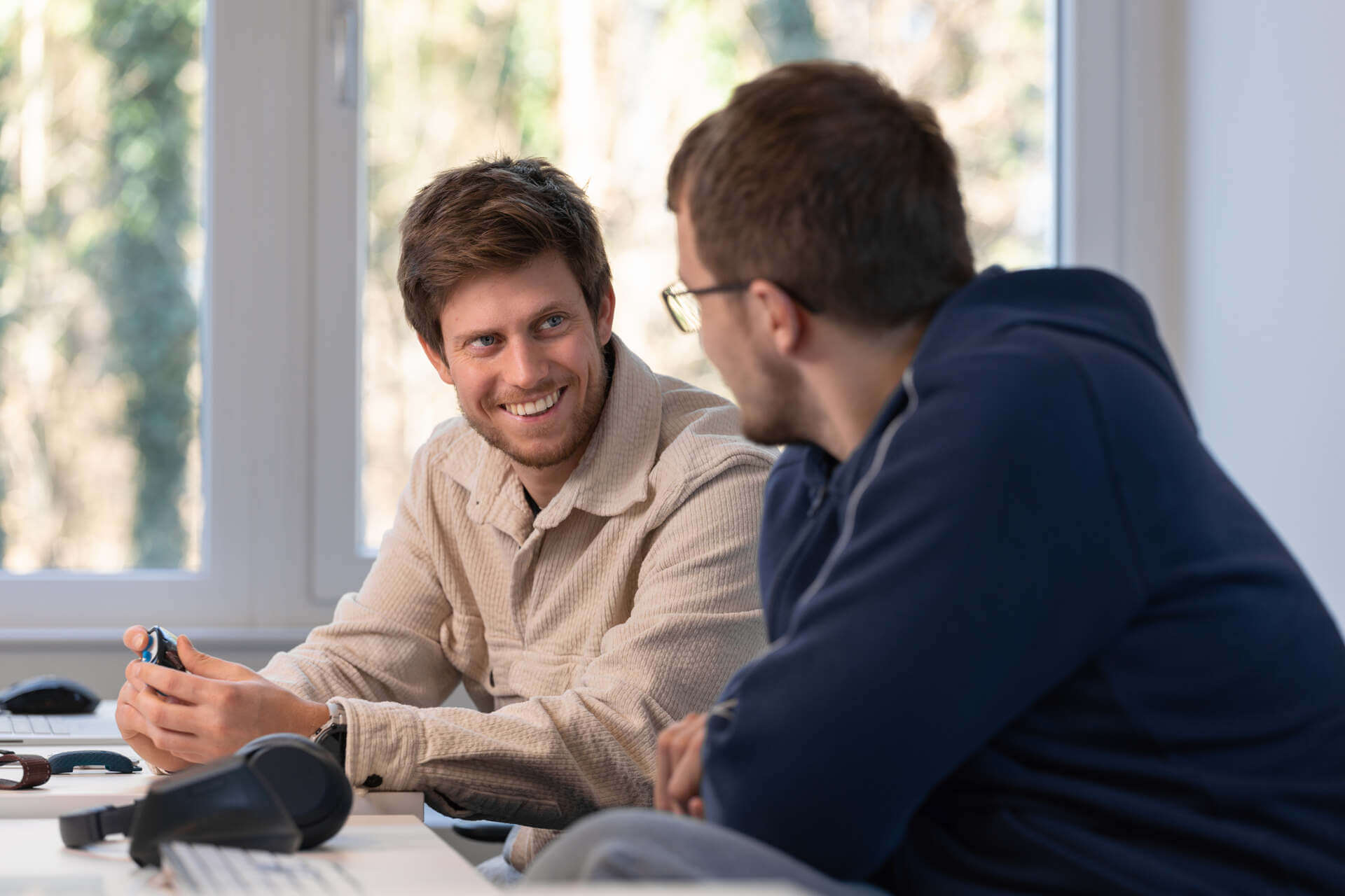 A pair of Tractive employees discussing work